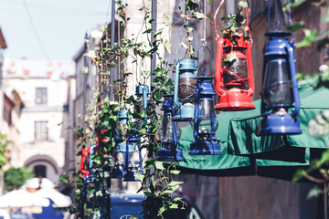 flower pots made of old oil lamps. decoration outside restaurant or cafe