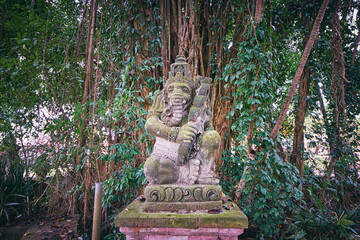 Religious decoration. Traditional stone sculpture of Ganesha god in jungle. Bali, Indonesia.