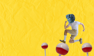 Contemporary art collage with young man with plaster head of ancient statue jumping on lollipops isolated on yellow background. Comparison of eras