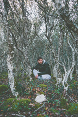 Young man alone in a huge forest