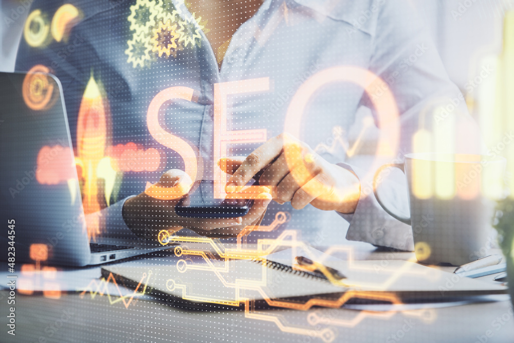 Poster double exposure of seo sketch hologram and woman holding and using a mobile device.