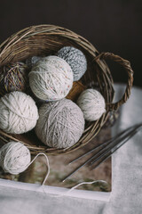 Balls of wool yarn with needles on a rustic background.  Concept for handmade and hygge slow life.