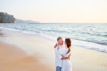 Fototapeta na wymiar Young loving couple on the sea beach.