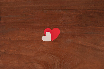 Isolated Red and white hearts of different sizes on rustic wooden background for Valentine's Day