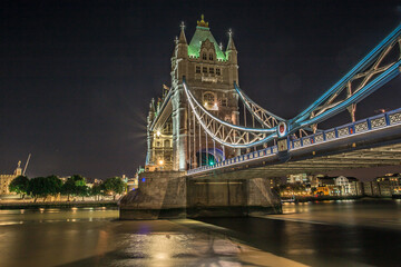 Fototapeta na wymiar The iconic Tower Bridge in London, view to the illuminated Tower Bridge and skyline of London, UK, just after sunset.