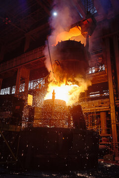 Ingot casting, metal sparks. Ladle-furnace. Iron smelting, Steel production. Electric steel furnace. Metallurgy. Industry steel production. 