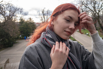 Young beautiful woman on the background of the park for relaxation