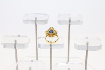 Blue Sapphire rings with Blue ribbon on white background. Jewelry set of gemstone and diamonds for shop