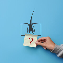 A silhouette of a human hair and a question mark next to it. Symbol of questions on the treatment of the scalp