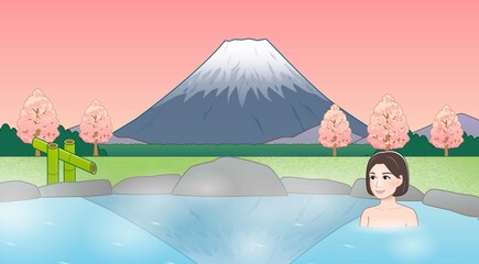 富士山が見えるところで温泉に入っている女性