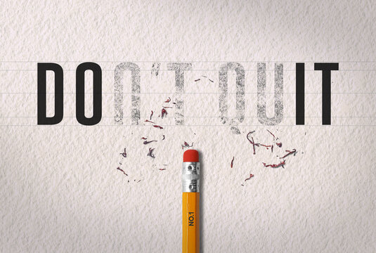 Positive thinking concept transforming the word &ldquo;don't quit&rdquo; to the word &ldquo;do it&rdquo; with pencil eraser on white paper