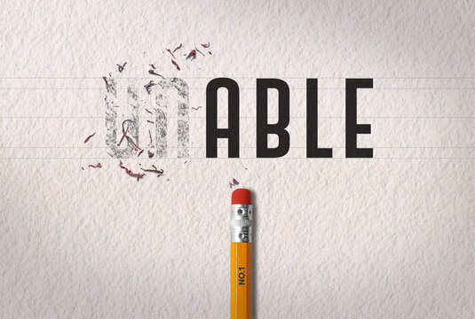 Positive thinking concept transforming the word &ldquo;unable&rdquo; to the word &ldquo;able&rdquo; with pencil eraser on white paper