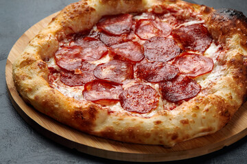 Tasty pepperoni pizza on black concrete background. Top view of hot pepperoni pizza. With copy space for text.