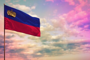 Fluttering Liechtenstein flag mockup with the space for your content on colorful cloudy sky background.
