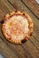 Pizza Margherita on wooden background, top view. Flyer and poster for Restaurants or pizzerias, template with delicious taste margarita pizza, mozzarella cheese