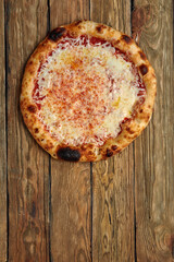 Pizza Margherita on wooden background, top view. Flyer and poster for Restaurants or pizzerias, template with delicious taste margarita pizza, mozzarella cheese