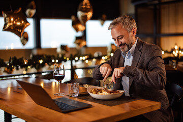 Satisfied caucasian adult man, cutting soft meat in a plate, with his knife.