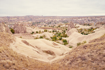Fototapeta na wymiar Travel and tourism in Turkey. Famous sightseeing Cappadocia, Anatolia. Beautiful landscape with mountains, caves and cloudy sky.