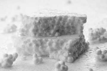 Stack of broken pieces of white styrofoam on the sheet of white styrofoam