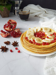 Stack of pancakes with fruits topping