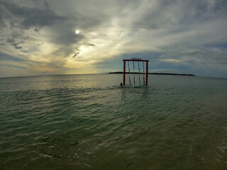 Hammock by the beach with sun setting. 