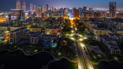 Skyscrapers in Barsha Heights district and low rise buildings in Greens district aerial night to day timelapse.