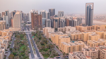 Obraz premium Skyscrapers in Barsha Heights district and low rise buildings in Greens district aerial timelapse. Dubai skyline