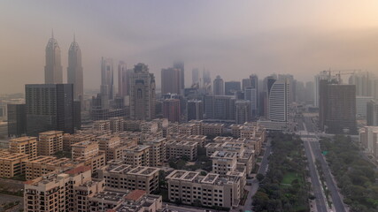 Skyscrapers in Barsha Heights district and low rise buildings in Greens district aerial timelapse. Dubai skyline