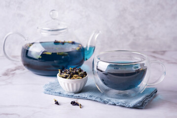 Obraz na płótnie Canvas Anchan from dry butterfly pea flower, blue tea in glass cup and teapot.