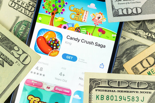 Candy Crush Saga mobile game app and money background
