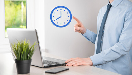 Businessman hand holds the icon of hours clock with arrow. Rapid execution of the work.Business...