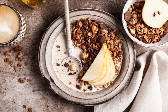 Chocolate granola with almond milk, pear and honey.