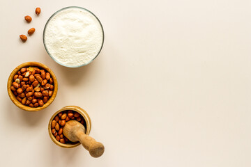 Pestle peanut flour - nuts with mortar on kitchen table