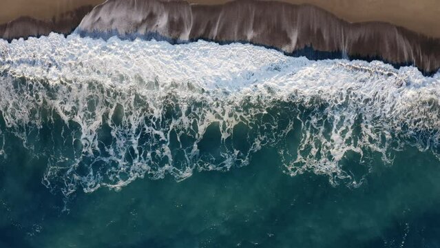 Aerial Overhead Of Stormy Waves Of Ocean And Beach