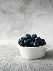White bowl with a heap of blueberries