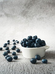 blueberries in a bowl and on the backdrop