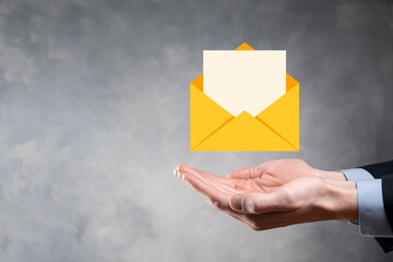 Businessman hand holding e-mail icon, Contact us by newsletter email and protect your personal...