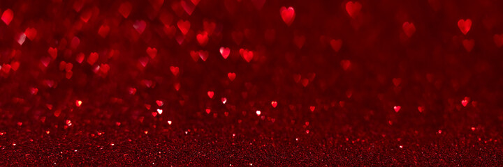 Red hearts, sparkling glitter bokeh background texture. Holiday valentines day lights. Abstract defocused header. Wide screen wallpaper. Panoramic web banner with copy space for design