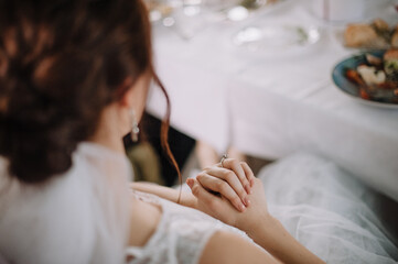 gentle touches of the bride's hand close-up