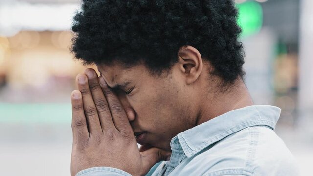 Close up troubled stressed african american man cover face with hands feeling mental pressure worry grief sorrow health trouble thinking looking for solution headache. Desperate sad guy upset break up