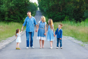 A Happy family walk along the road in the park on nature background