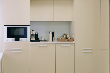 Kitchen wall cabinet. Symple beige furniture in kitchen room.