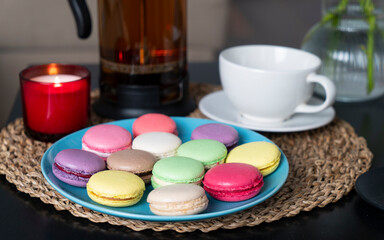 Macaroons and hot black tea on the table