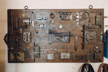 Vintage old handmade crafted key and locks on a wooden table.