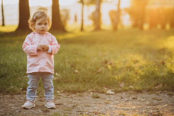 Cute toddler girl in autumnal park