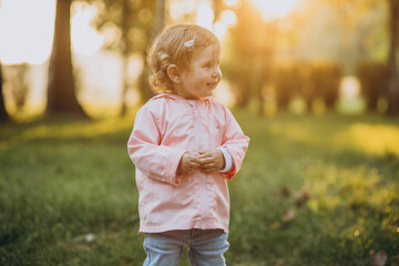 Cute toddler girl in autumnal park