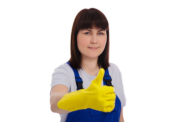 cheerful woman in blue coverall and yellow rubber gloves thumbs up isolated on white