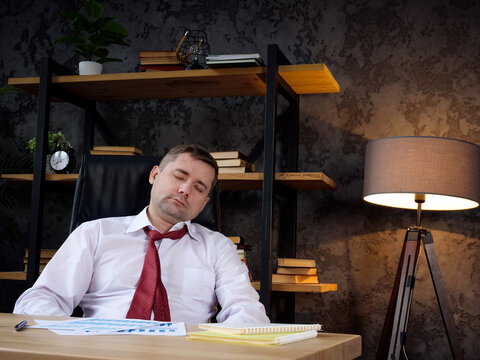 Tired employee sleeps at the workplace. Burnout and exhaustion concept.