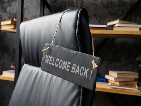 Office chair with welcome back sign. Reemployment concept.