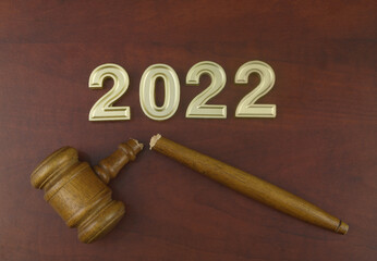 Law cancelation and injustice in 2022 concept. Broken judge gavel and numbers 2022.